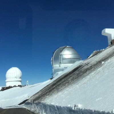 snow-covered mountain with telescopes