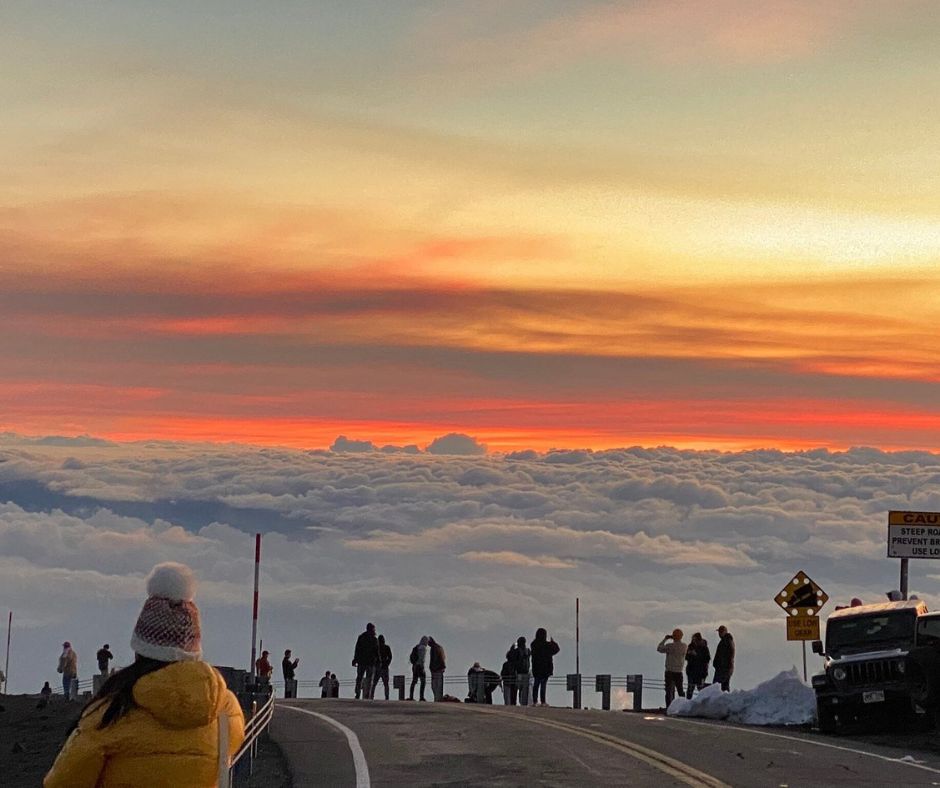 People watching the amazing sunset over the clouds on the Summit of Mauna Kea Sunset Arnott's Lodging and Adventures