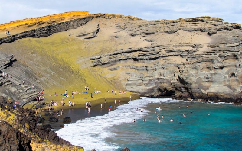 tourists swimming in the bay of the Green Sand Beach